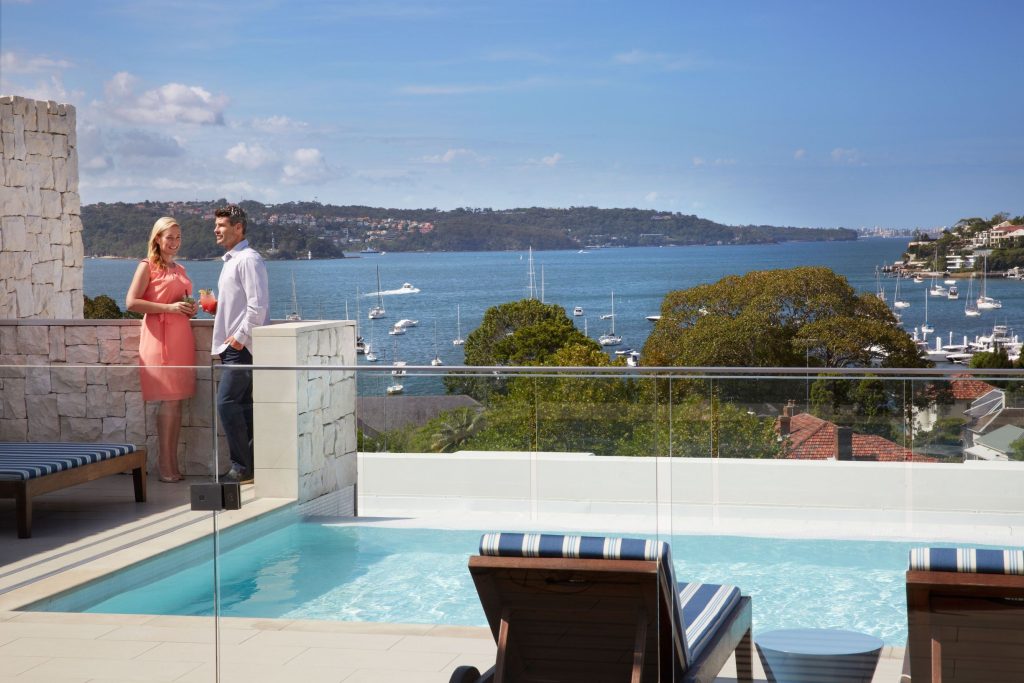 Couple enjoying drinks by the pool at the Intercontinental Hotel, Double Bay.